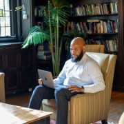 group in suits around laptops